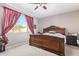 Spacious bedroom with large window and wooden bed frame at 22860 S 226Th St, Queen Creek, AZ 85142