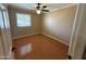 Cozy bedroom with hardwood floors, a ceiling fan, and a window offering plenty of natural light at 2331 W Onza Ave, Mesa, AZ 85202