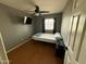 Bedroom with hard wood floor, ceiling fan, window and tv mounted on the wall at 2331 W Onza Ave, Mesa, AZ 85202
