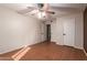 Well-lit bedroom with wood floors and access to another room at 2331 W Onza Ave, Mesa, AZ 85202