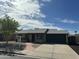 Charming single-story home with a well-maintained front yard and a paved walkway, features a two-car garage at 2331 W Onza Ave, Mesa, AZ 85202