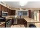 L-shaped kitchen with granite countertops and wood cabinets at 2331 W Onza Ave, Mesa, AZ 85202