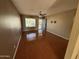 Bright living room featuring hardwood floors, a ceiling fan, and a large window for natural light at 2331 W Onza Ave, Mesa, AZ 85202
