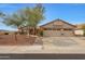 Tan house with 3-car garage and landscaped yard at 23404 N 45Th Ave, Glendale, AZ 85310