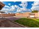 Large backyard with patio, grassy area, and swing set at 25700 W St James Ave, Buckeye, AZ 85326