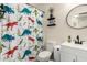 Bathroom with dinosaur shower curtain and updated vanity at 25700 W St James Ave, Buckeye, AZ 85326