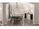 Elegant dining room with a large table, pendant lighting, and access to kitchen at 25700 W St James Ave, Buckeye, AZ 85326