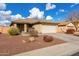 One-story house with beige exterior, attached garage, and landscaped front yard at 25700 W St James Ave, Buckeye, AZ 85326