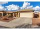 One-story house with beige exterior, attached garage, and landscaped front yard at 25700 W St James Ave, Buckeye, AZ 85326