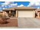 One-story house with beige exterior, attached garage, and landscaped front yard at 25700 W St James Ave, Buckeye, AZ 85326