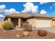 One-story house with beige exterior, attached garage, and landscaped front yard at 25700 W St James Ave, Buckeye, AZ 85326