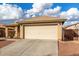 One-story house with beige exterior, attached garage, and landscaped front yard at 25700 W St James Ave, Buckeye, AZ 85326