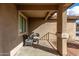 Covered front porch with two wicker chairs and a view of the front yard at 25700 W St James Ave, Buckeye, AZ 85326