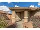 Covered front porch with two wicker chairs and a view of the front yard at 25700 W St James Ave, Buckeye, AZ 85326