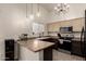 Modern kitchen with L-shaped counter, stainless steel appliances, and ample cabinet space at 25700 W St James Ave, Buckeye, AZ 85326