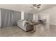 Spacious living room with gray sectional sofa and wood-look flooring at 25700 W St James Ave, Buckeye, AZ 85326