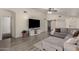 Open living area showcasing comfortable seating, hardwood floors, and large TV at 25700 W St James Ave, Buckeye, AZ 85326