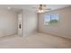 Bright bedroom with ceiling fan and access to bathroom at 26234 W Behrend Dr, Buckeye, AZ 85396
