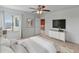 Bedroom with large TV, ceiling fan and access to upper loft at 26234 W Behrend Dr, Buckeye, AZ 85396