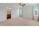 Spacious bedroom with ceiling fan and large windows at 26234 W Behrend Dr, Buckeye, AZ 85396