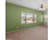 Bedroom with pool view, ceiling fan, and neutral carpeting at 26234 W Behrend Dr, Buckeye, AZ 85396