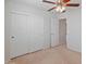 Bright bedroom with ceiling fan and double door closet at 26234 W Behrend Dr, Buckeye, AZ 85396