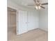 Spacious bedroom with double door closet and access to hallway at 26234 W Behrend Dr, Buckeye, AZ 85396