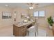 Well-lit home office with a wooden desk, comfortable chair, and a neutral color scheme at 26234 W Behrend Dr, Buckeye, AZ 85396
