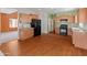 Bright kitchen features wood cabinets, black appliances, and wood-look flooring at 26234 W Behrend Dr, Buckeye, AZ 85396