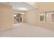 Bright living room with a view to the backyard patio through sliding glass doors and a window view at 26234 W Behrend Dr, Buckeye, AZ 85396