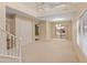 Bright living room with a view to the backyard pool through sliding glass doors and a staircase visible at 26234 W Behrend Dr, Buckeye, AZ 85396