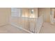 Bright loft with a view to the staircase and a carpeted floor plan at 26234 W Behrend Dr, Buckeye, AZ 85396