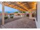 Covered patio with pergola lighting and brick pavers at 26234 W Behrend Dr, Buckeye, AZ 85396
