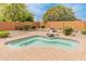 Kidney shaped pool with brick coping and fountain at 26234 W Behrend Dr, Buckeye, AZ 85396