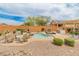 Inviting backyard with a pool, patio, and outdoor kitchen at 26234 W Behrend Dr, Buckeye, AZ 85396