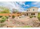 Landscaped backyard with a pool, patio, and fountain at 26234 W Behrend Dr, Buckeye, AZ 85396