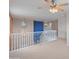 Upstairs hallway features neutral carpeting and a ceiling fan at 26234 W Behrend Dr, Buckeye, AZ 85396