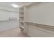 Large walk-in closet with shelves and hanging rods at 26234 W Behrend Dr, Buckeye, AZ 85396