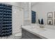 Bathroom with gray vanity, white countertop and blue shower curtain at 2683 E Indigo Pl, Chandler, AZ 85286