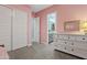 Bedroom with white dresser, en-suite bathroom, and pink walls at 2683 E Indigo Pl, Chandler, AZ 85286