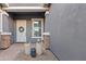 Front entry with white door, stone accents, and potted plants at 2683 E Indigo Pl, Chandler, AZ 85286