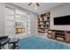 Gathering room features built-in shelving, and sliding barn doors at 2683 E Indigo Pl, Chandler, AZ 85286
