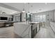 Modern kitchen with large island, white cabinets, and stainless steel appliances at 2683 E Indigo Pl, Chandler, AZ 85286