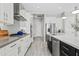 Modern kitchen with large island, white cabinets, and stainless steel appliances at 2683 E Indigo Pl, Chandler, AZ 85286