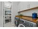 Laundry room with washer, dryer, and well-organized storage at 2683 E Indigo Pl, Chandler, AZ 85286