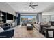 Spacious living room with sectional sofa, large TV, and sliding glass doors to backyard at 2683 E Indigo Pl, Chandler, AZ 85286