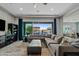 Spacious living room with sectional sofa, large TV, and sliding glass doors to backyard at 2683 E Indigo Pl, Chandler, AZ 85286