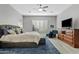 Spacious main bedroom with plush bedding and a large TV at 2683 E Indigo Pl, Chandler, AZ 85286