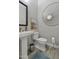 Stylish powder room with pedestal sink and decorative mirror at 2683 E Indigo Pl, Chandler, AZ 85286