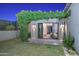 Landscaped backyard with lush lawn, a pergola covered in vines, and sliding door access to the Primary suite at 28869 N 91St Ave, Peoria, AZ 85383